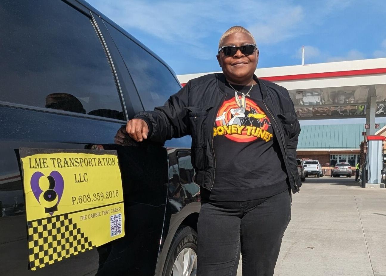 Michelle Horton standing beside an LME Transportation passenger van in Janesville.